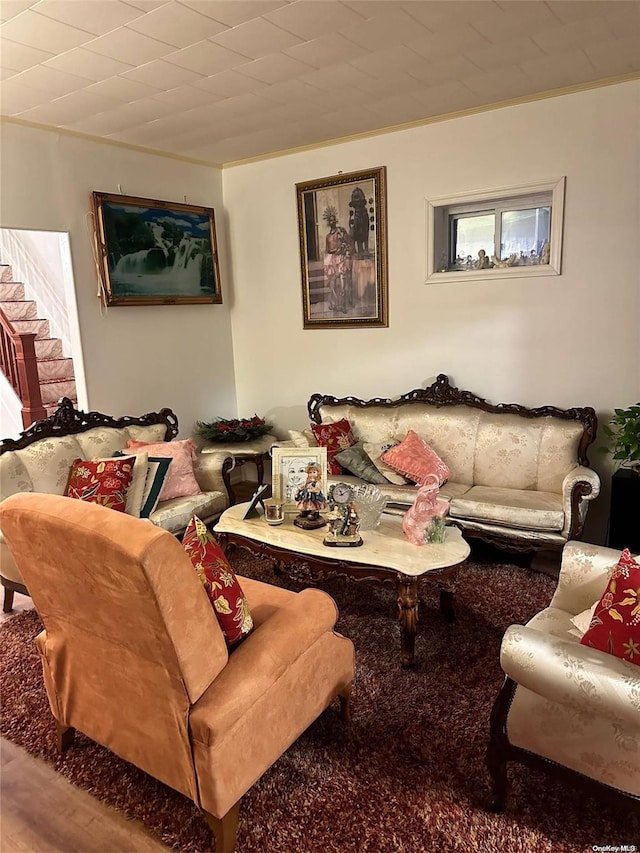 living room with hardwood / wood-style floors and crown molding