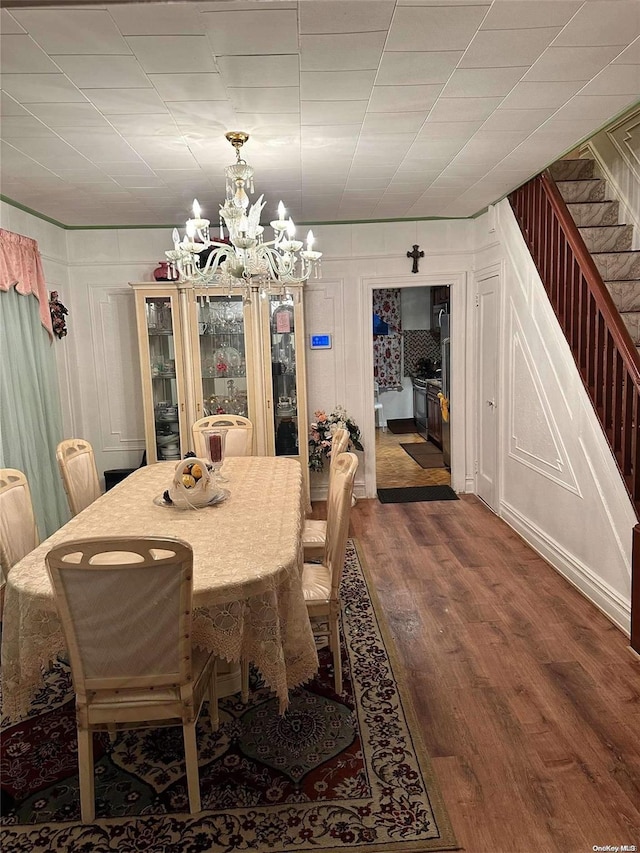 dining space featuring dark hardwood / wood-style floors and a chandelier