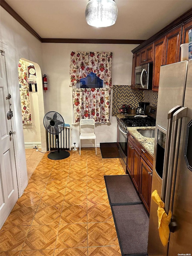 kitchen featuring backsplash, ornamental molding, light stone counters, stainless steel appliances, and light parquet flooring