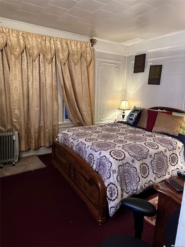 bedroom with radiator and carpet floors