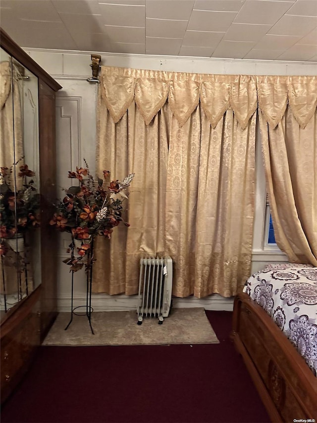 carpeted bedroom with radiator