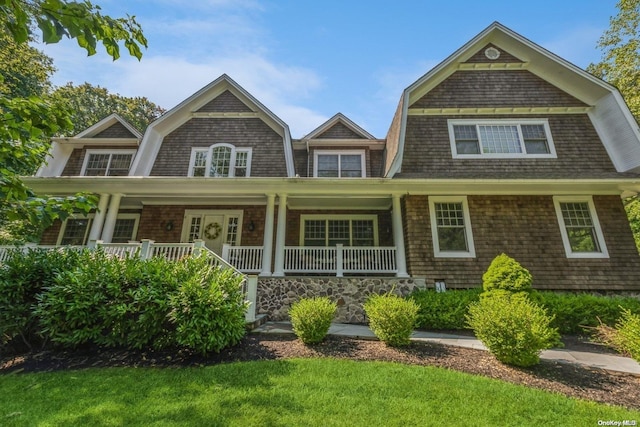 shingle-style home with a gambrel roof and covered porch