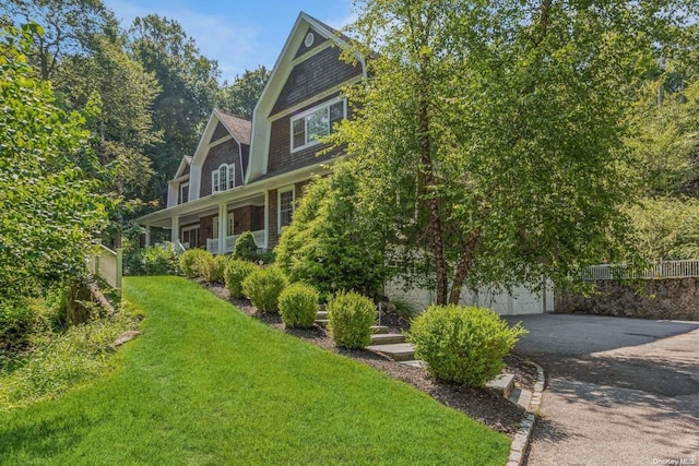 exterior space featuring a garage and a front yard