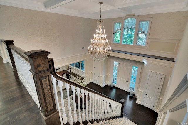 entryway with beam ceiling, dark hardwood / wood-style flooring, crown molding, and coffered ceiling