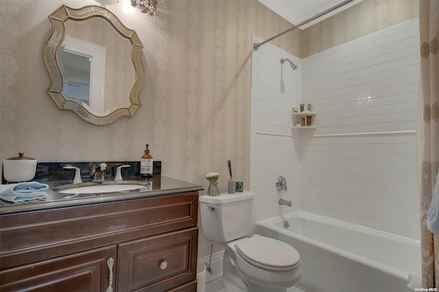 full bathroom with vanity, toilet, tiled shower / bath, and ornamental molding