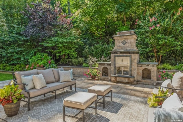 view of patio with an outdoor living space with a fireplace