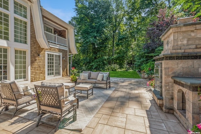 view of patio / terrace with an outdoor living space with a fireplace