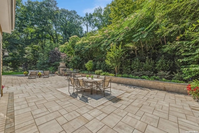 view of patio with an outdoor fireplace