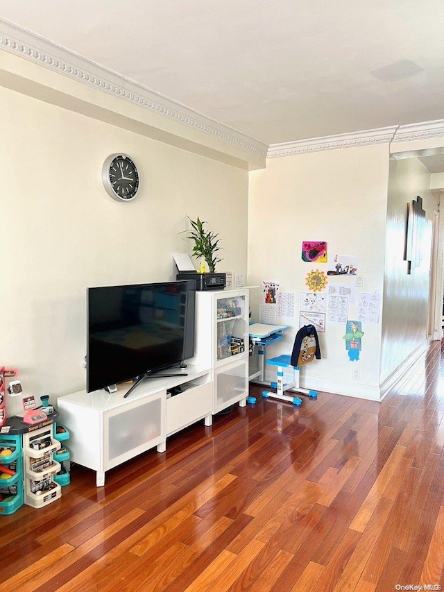 playroom with wood-type flooring and crown molding