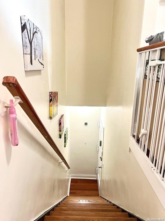 stairway with hardwood / wood-style flooring