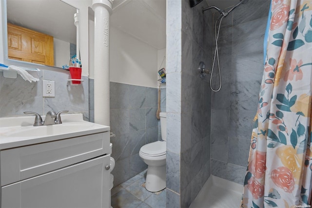 bathroom featuring tile patterned floors, toilet, vanity, tile walls, and a shower with shower curtain