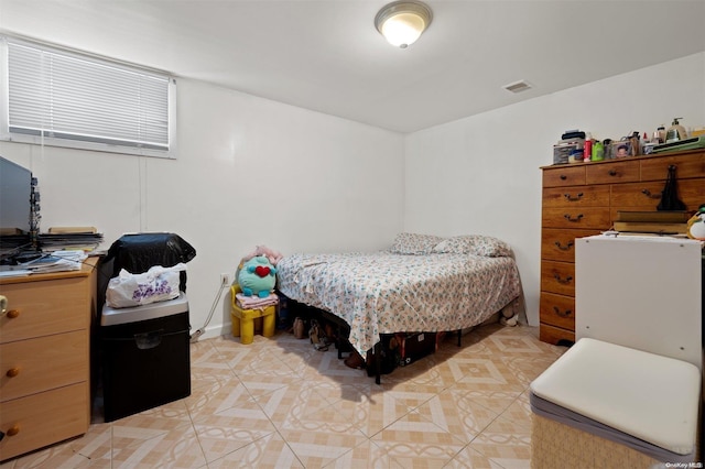 bedroom with light tile patterned floors