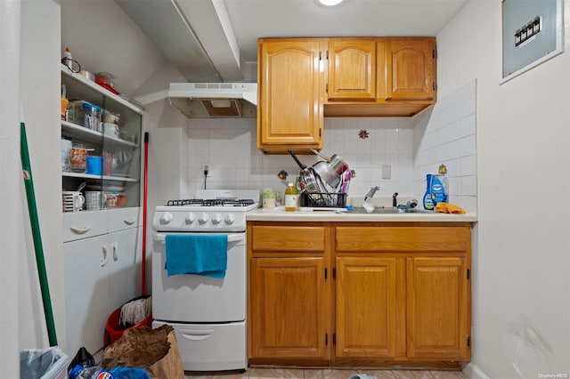 kitchen with white range oven, tasteful backsplash, and sink