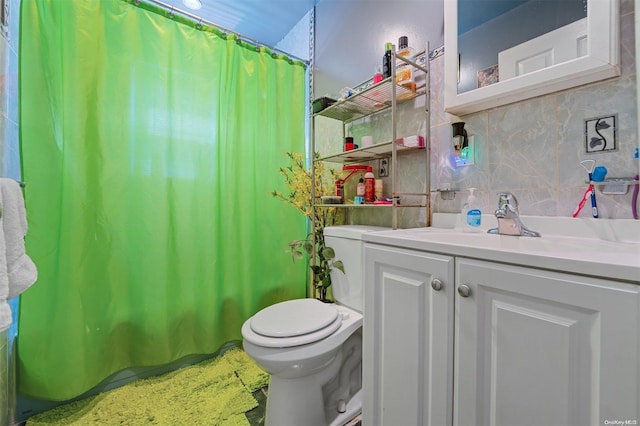 bathroom featuring backsplash, vanity, and toilet