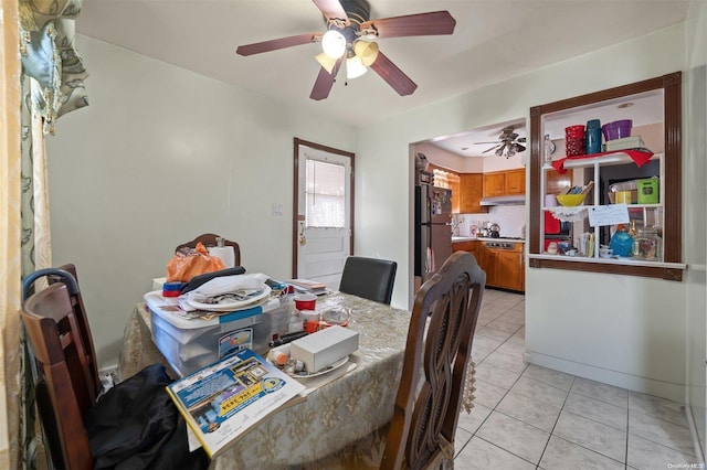 tiled dining area with ceiling fan