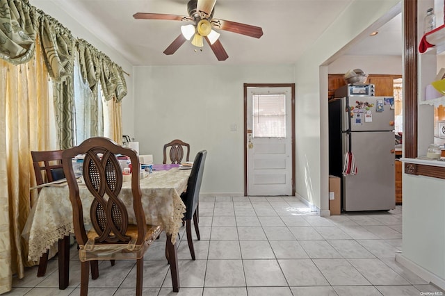 dining room with ceiling fan and light tile patterned flooring