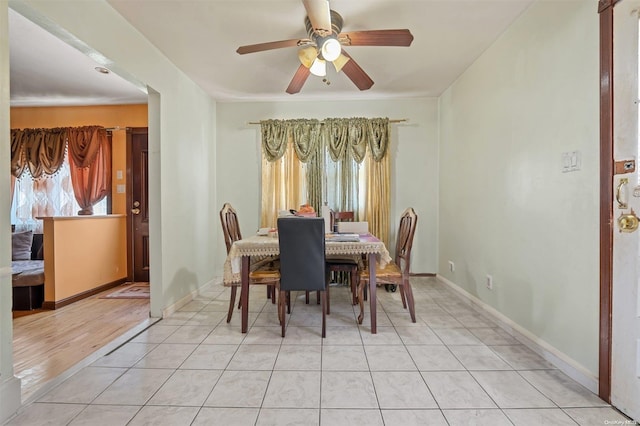 dining space with ceiling fan and light tile patterned floors