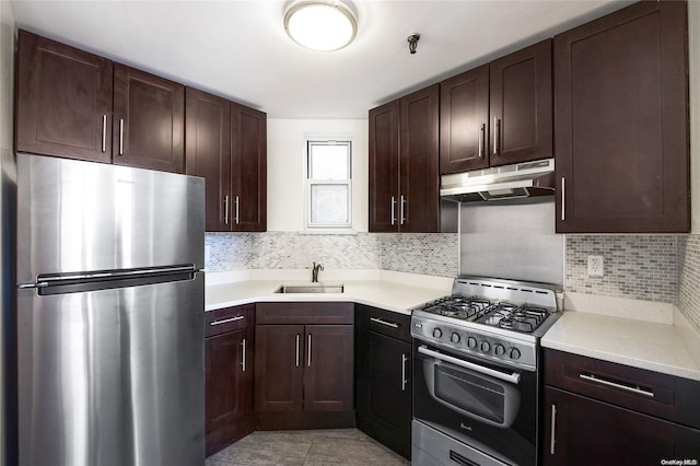 kitchen featuring decorative backsplash, sink, light tile patterned flooring, and appliances with stainless steel finishes