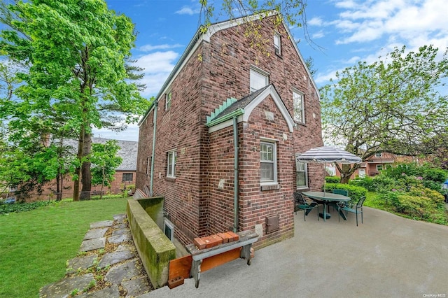 view of home's exterior featuring a lawn and a patio area