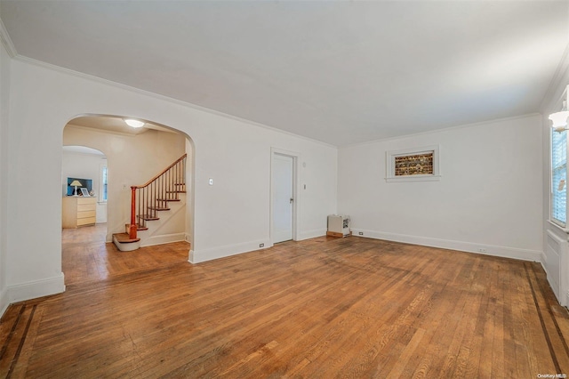 empty room featuring hardwood / wood-style flooring and crown molding