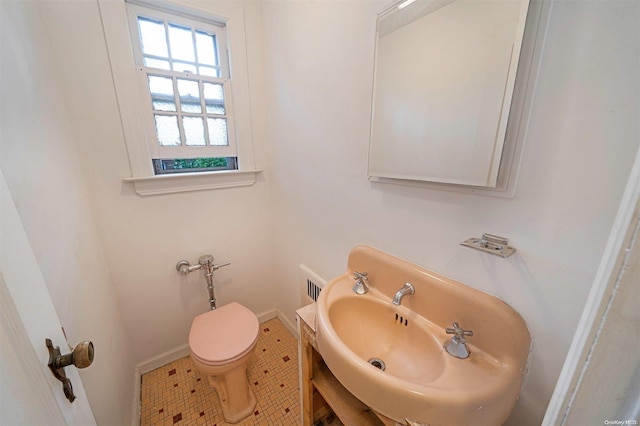 bathroom featuring tile patterned flooring, toilet, and sink