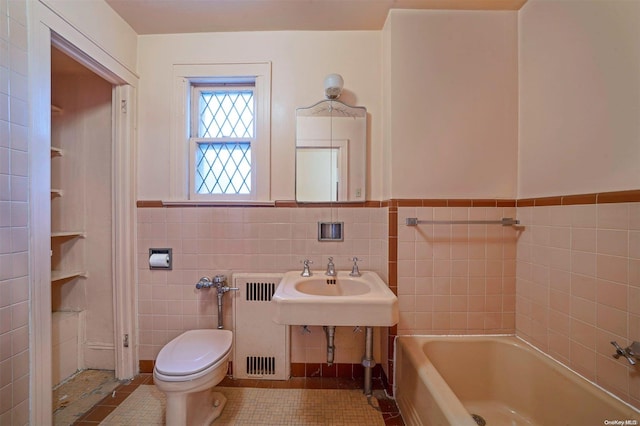 bathroom featuring a bath, tile patterned floors, toilet, tile walls, and radiator heating unit