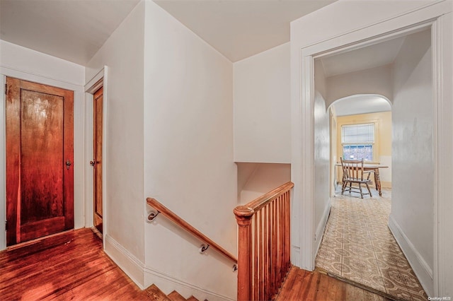 hallway with hardwood / wood-style floors