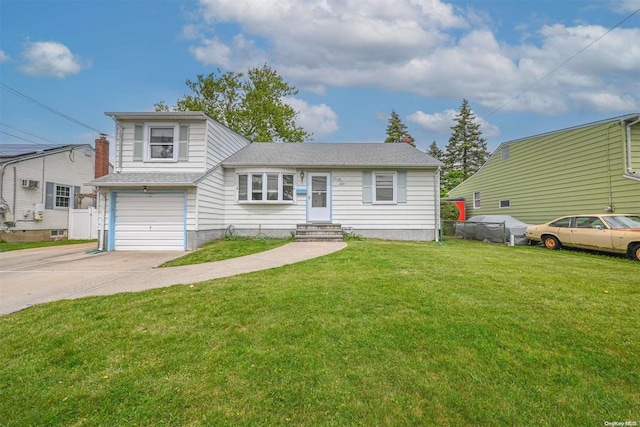 view of front of house with a garage and a front lawn