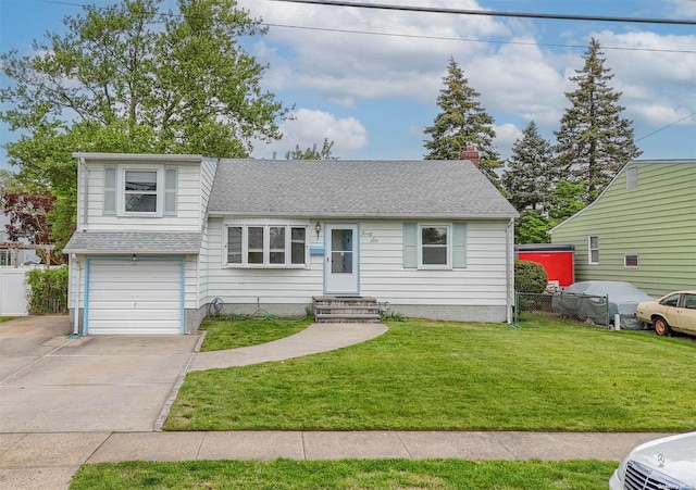 tri-level home with a front yard and a garage