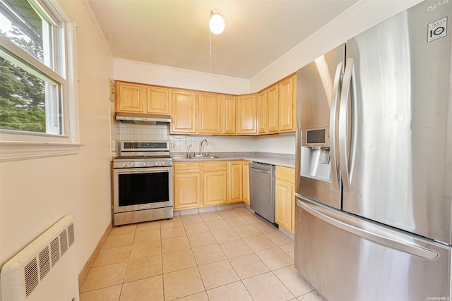 kitchen featuring light brown cabinets, light tile patterned floors, appliances with stainless steel finishes, and tasteful backsplash