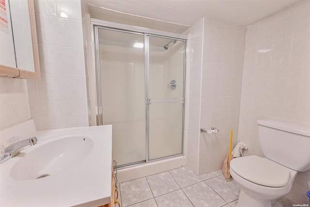 bathroom featuring tile patterned floors and tile walls