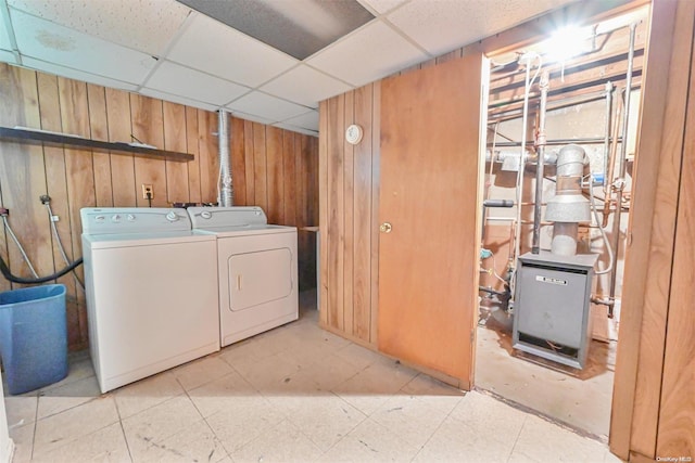 laundry area featuring separate washer and dryer and wooden walls