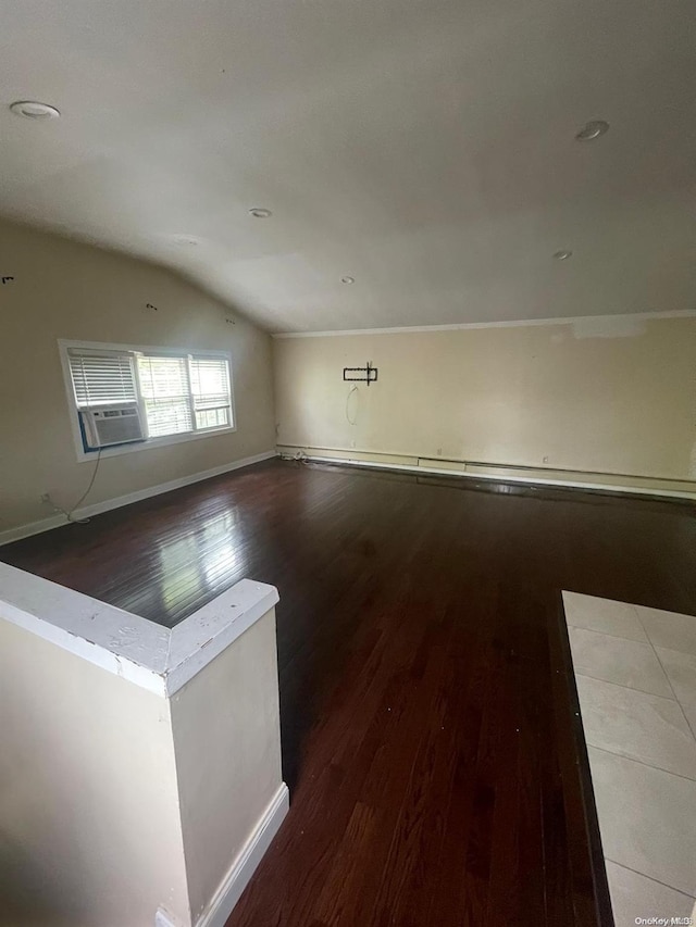 empty room featuring dark hardwood / wood-style floors and lofted ceiling