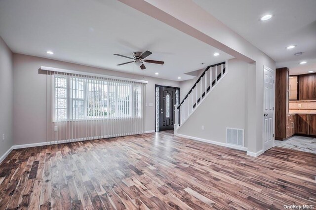 6 George Ave, Hicksville, NY 11801 - unfurnished living room with wood finished floors, ceiling fan, recessed lighting, and stairway