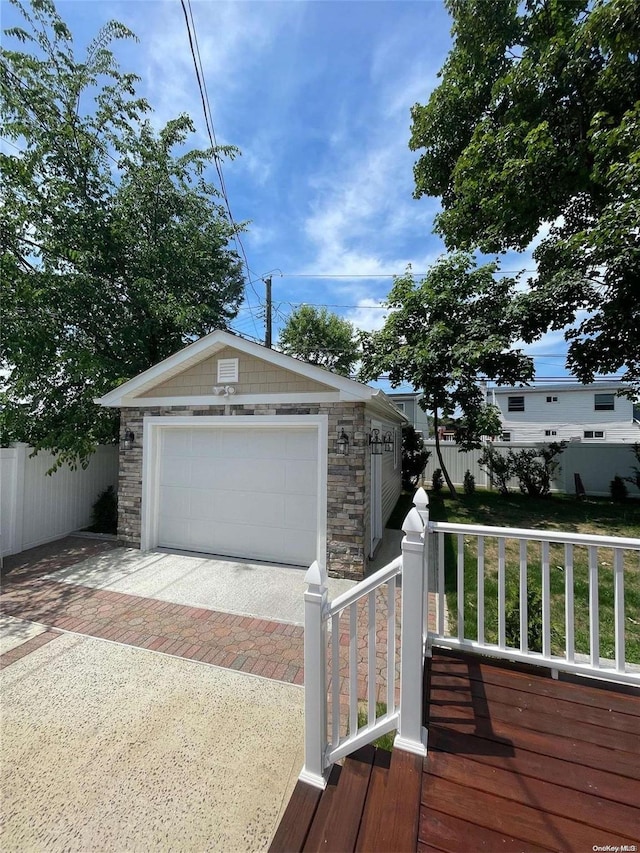 6 George Ave, Hicksville, NY 11801 - view of front of home with stone siding, an outbuilding, decorative driveway, and a detached garage