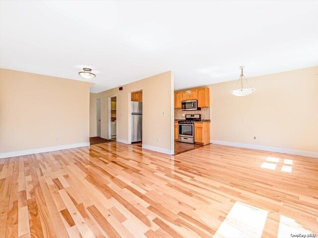 unfurnished living room featuring light hardwood / wood-style floors