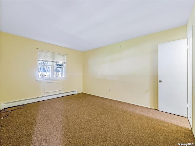 empty room with carpet flooring and a baseboard heating unit