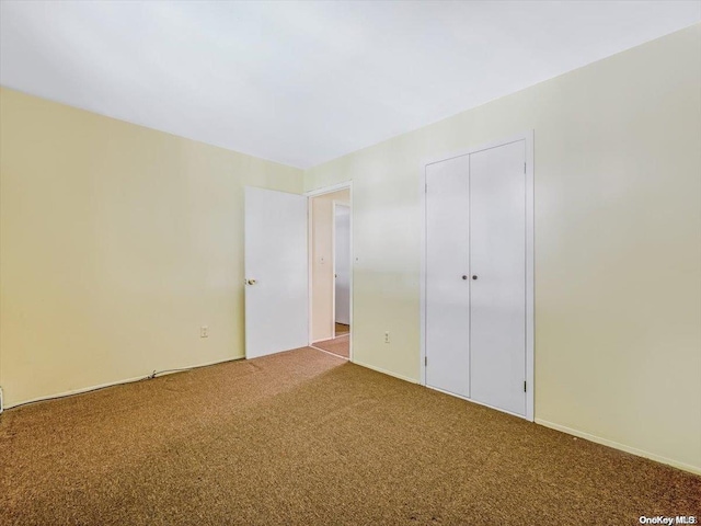 unfurnished bedroom featuring a closet and carpet