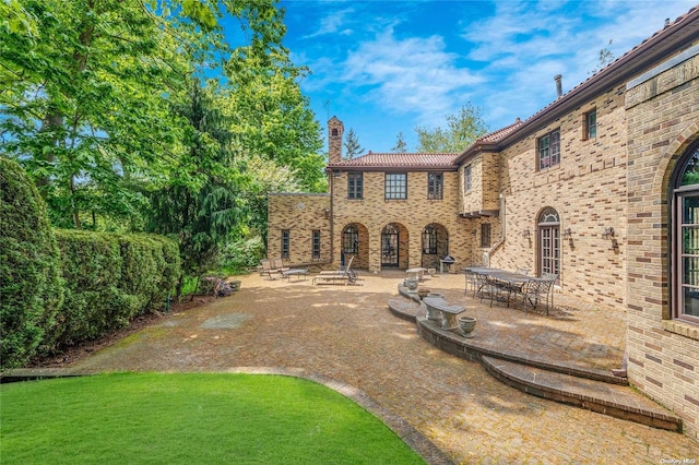 exterior space featuring a lawn and a patio area