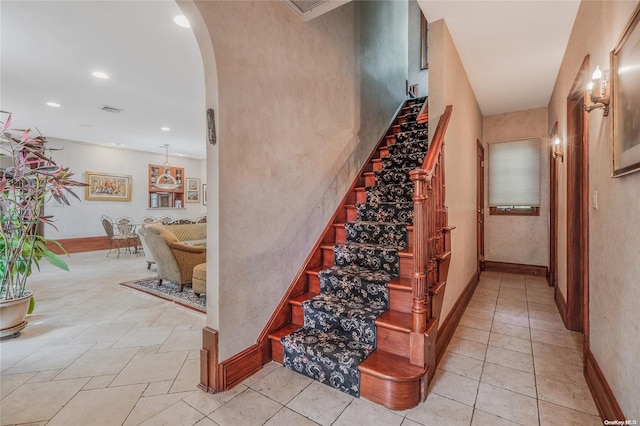 stairway with tile patterned flooring