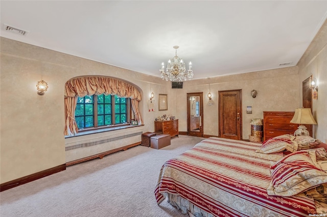 bedroom featuring a notable chandelier and carpet floors