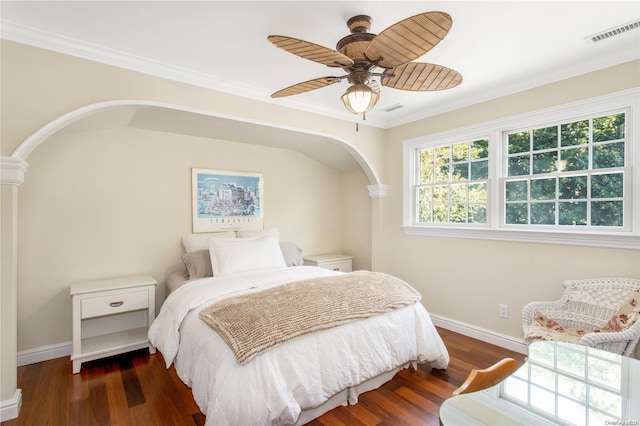 bedroom with dark hardwood / wood-style floors, ceiling fan, and ornamental molding