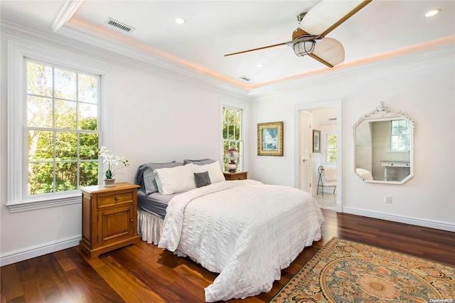 bedroom featuring ceiling fan, ornamental molding, dark wood-type flooring, and multiple windows