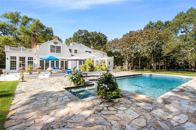 view of pool featuring an in ground hot tub and a patio