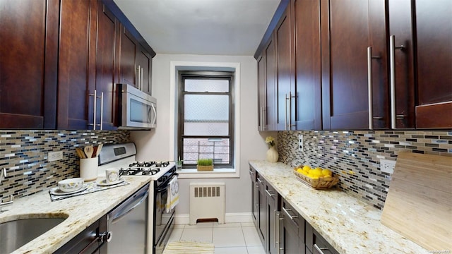 kitchen with tasteful backsplash, light stone countertops, a healthy amount of sunlight, and stainless steel appliances