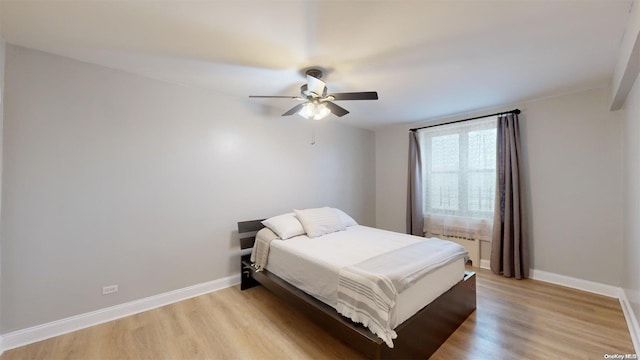 bedroom with ceiling fan and light hardwood / wood-style floors