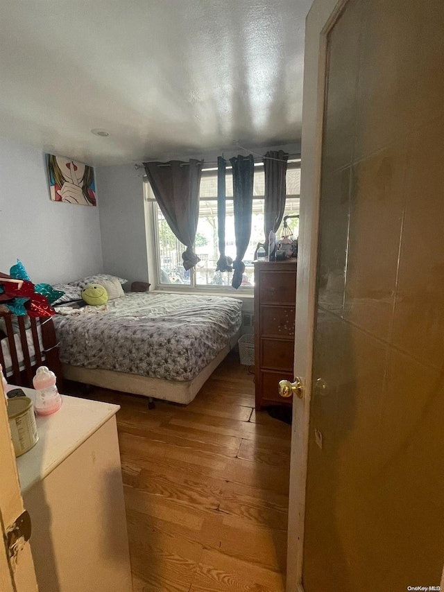 bedroom with hardwood / wood-style floors