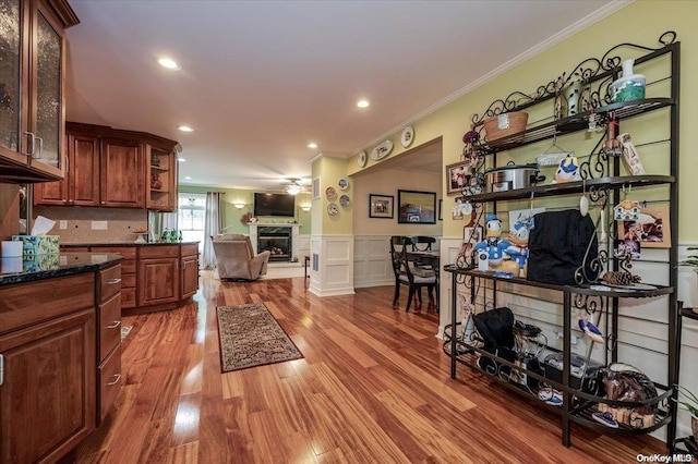 kitchen featuring tasteful backsplash, crown molding, and wood-type flooring