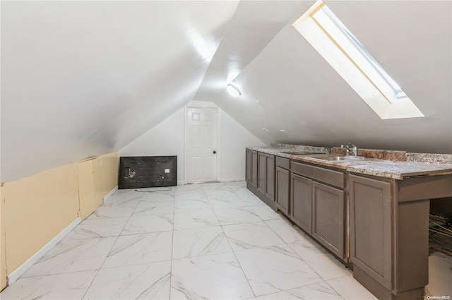 bonus room with lofted ceiling with skylight and sink