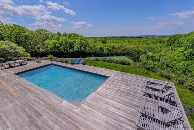 view of swimming pool with a deck